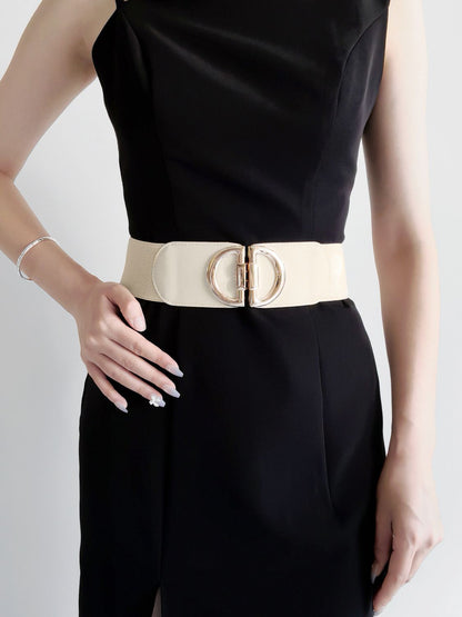 Black dress with a beige belt on a white background