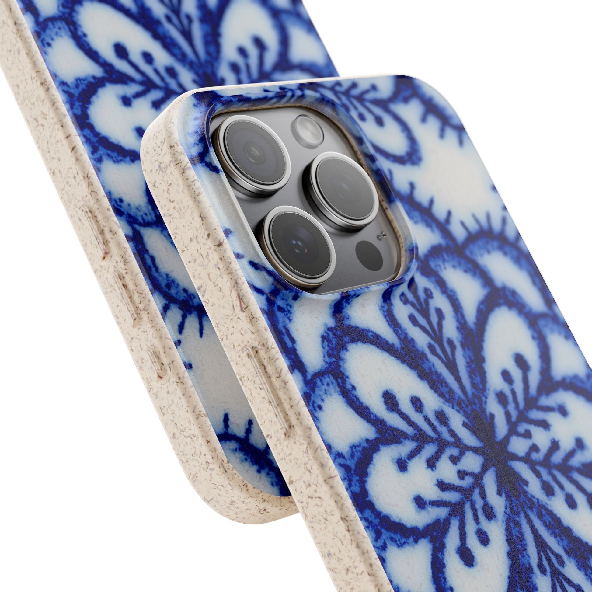 A close-up of a smartphone case with a blue and white floral mandala pattern and a natural beige textured edge, shown on a white background.