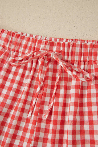 Red and white gingham fabric shorts with an elastic waistband and matching fabric tie bow.