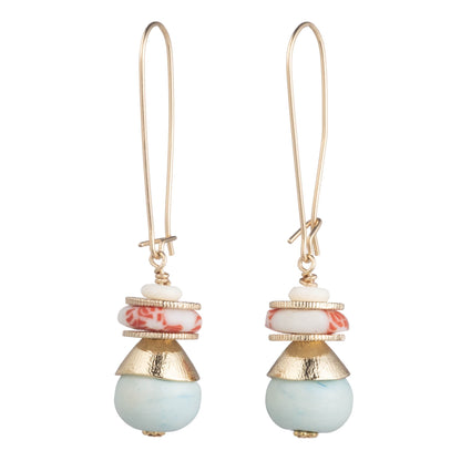 A pair of gold-tone drop earrings featuring a stacked design with a white and red marbled bead, a textured gold cone, and a smooth round light blue bead at the bottom, shown against a plain white background.