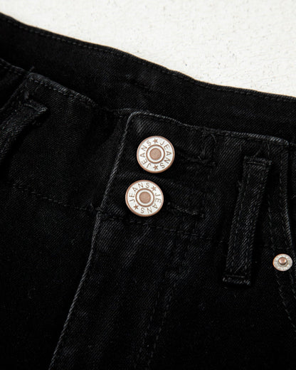 Close-up of black pants with buttons on a white background