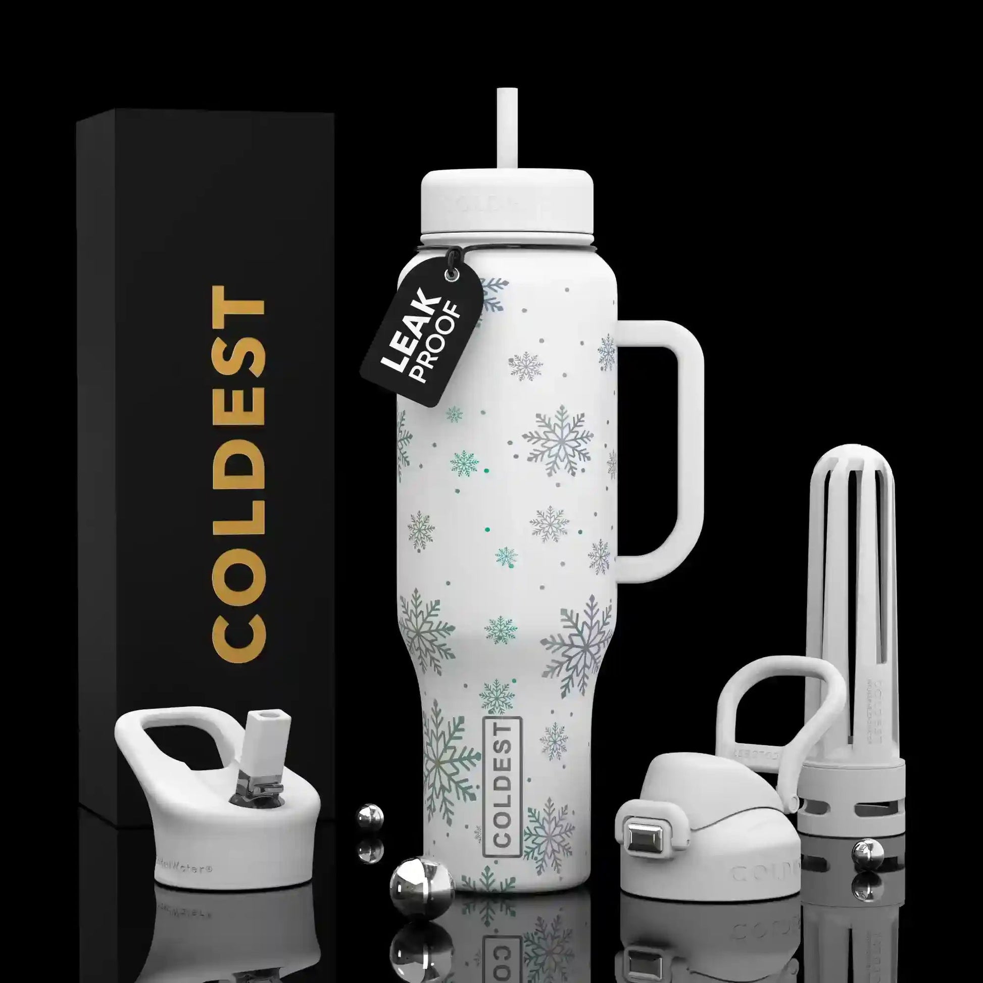 White insulated bottle with snowflake design, packaging, and accessories on a black background