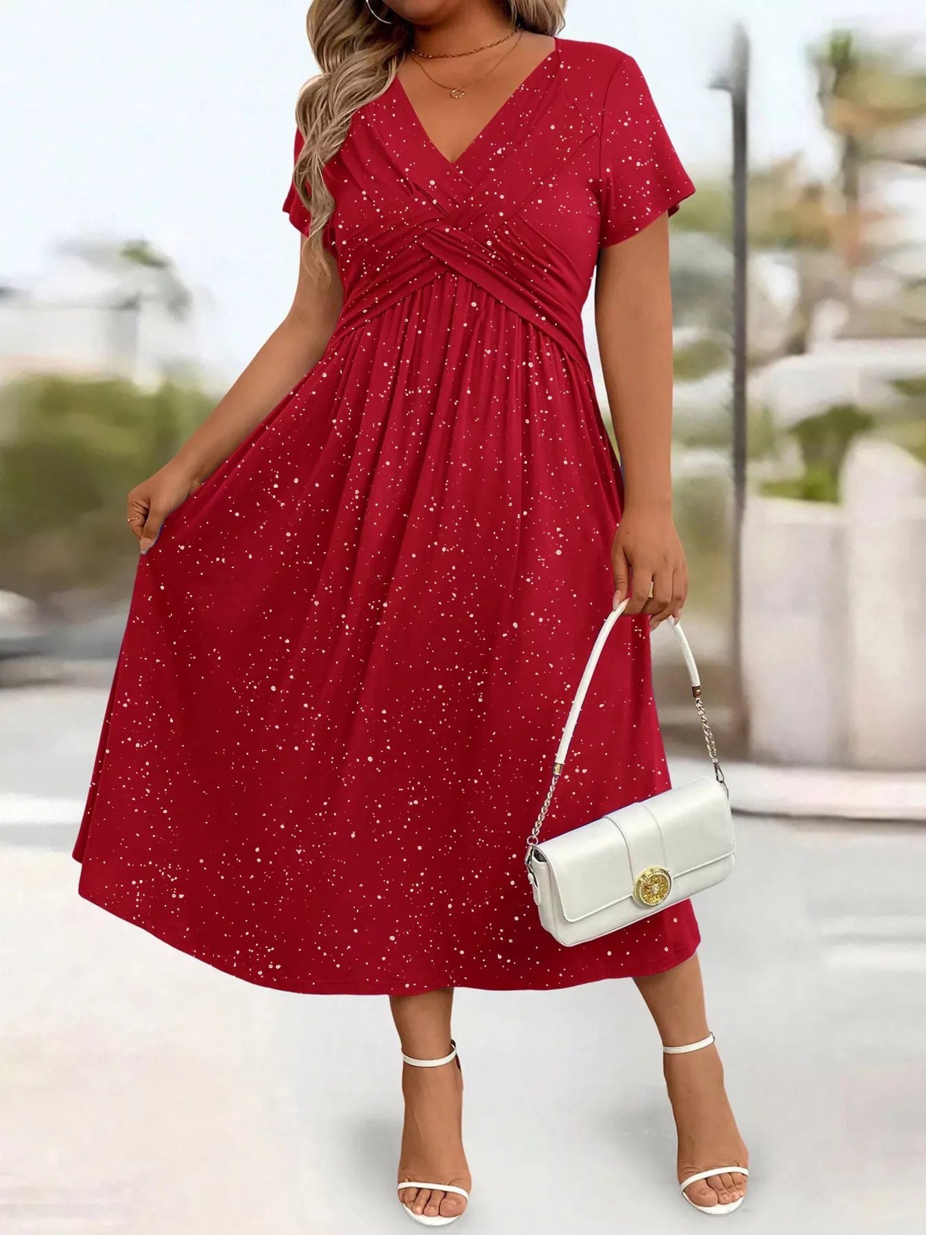 Woman wearing a red dress with a blurred outdoor background