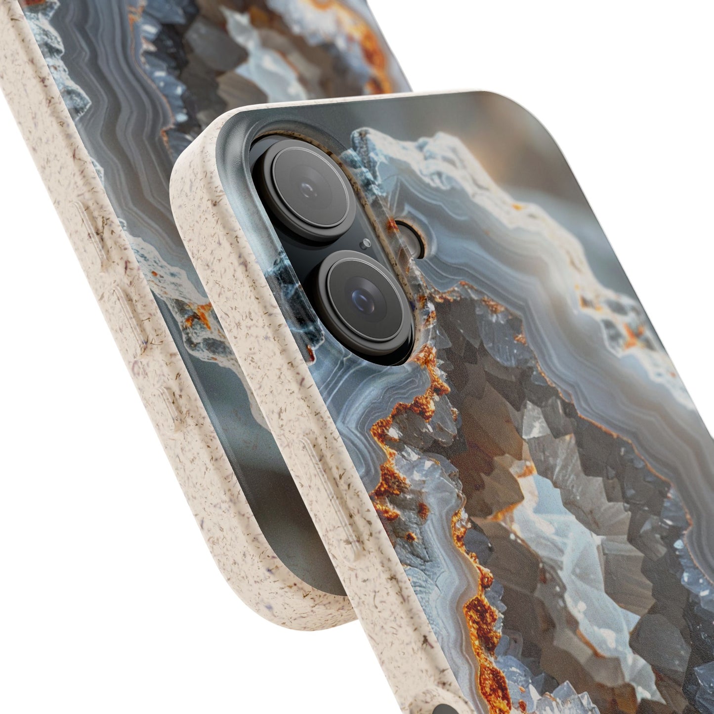 A close-up of a smartphone case with a geode and agate-inspired pattern in shades of gray, blue, and brown, featuring a textured beige bumper edge.