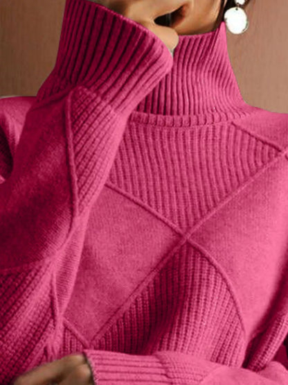 A close-up of a person wearing a bright pink ribbed turtleneck sweater, showing the high collar, textured knit pattern, and part of the face and earring.