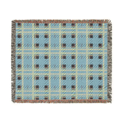 A square woven throw blanket with a light blue plaid pattern, featuring cream, brown, and gray stripes, fringed edges, and a subtle woven texture, shown flat on a white background.