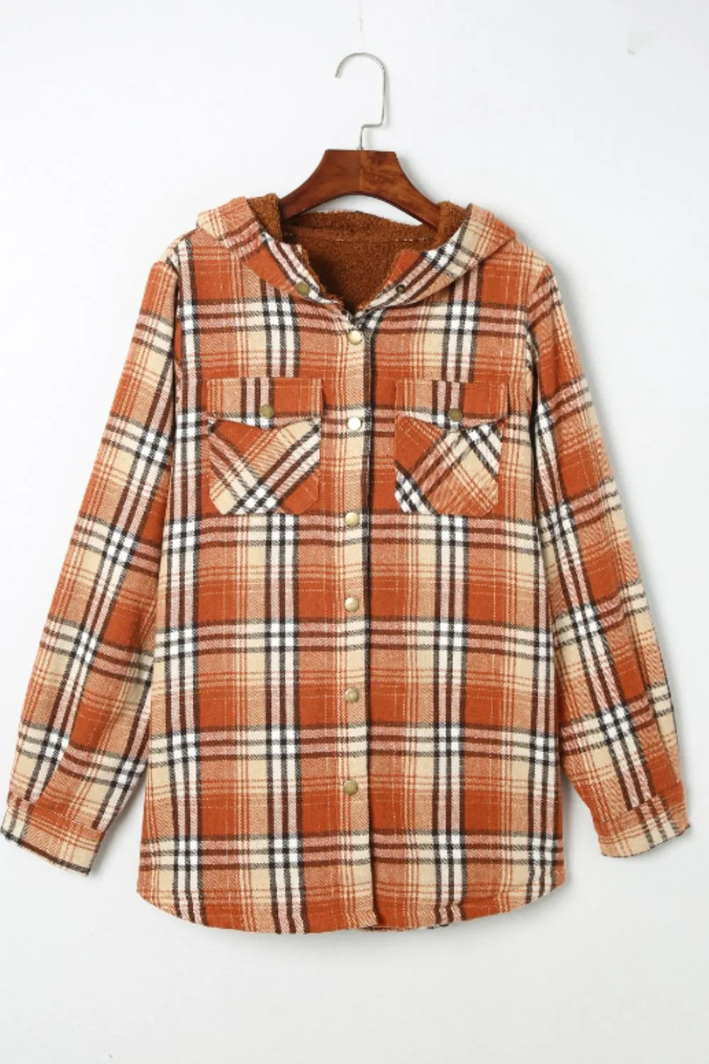 Plaid shirt on a hanger against a white background