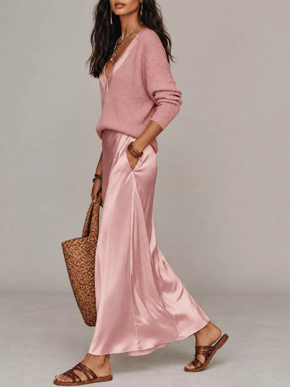Side view of pink V-neck top and satin midi skirt, showing the skirt’s side pocket.