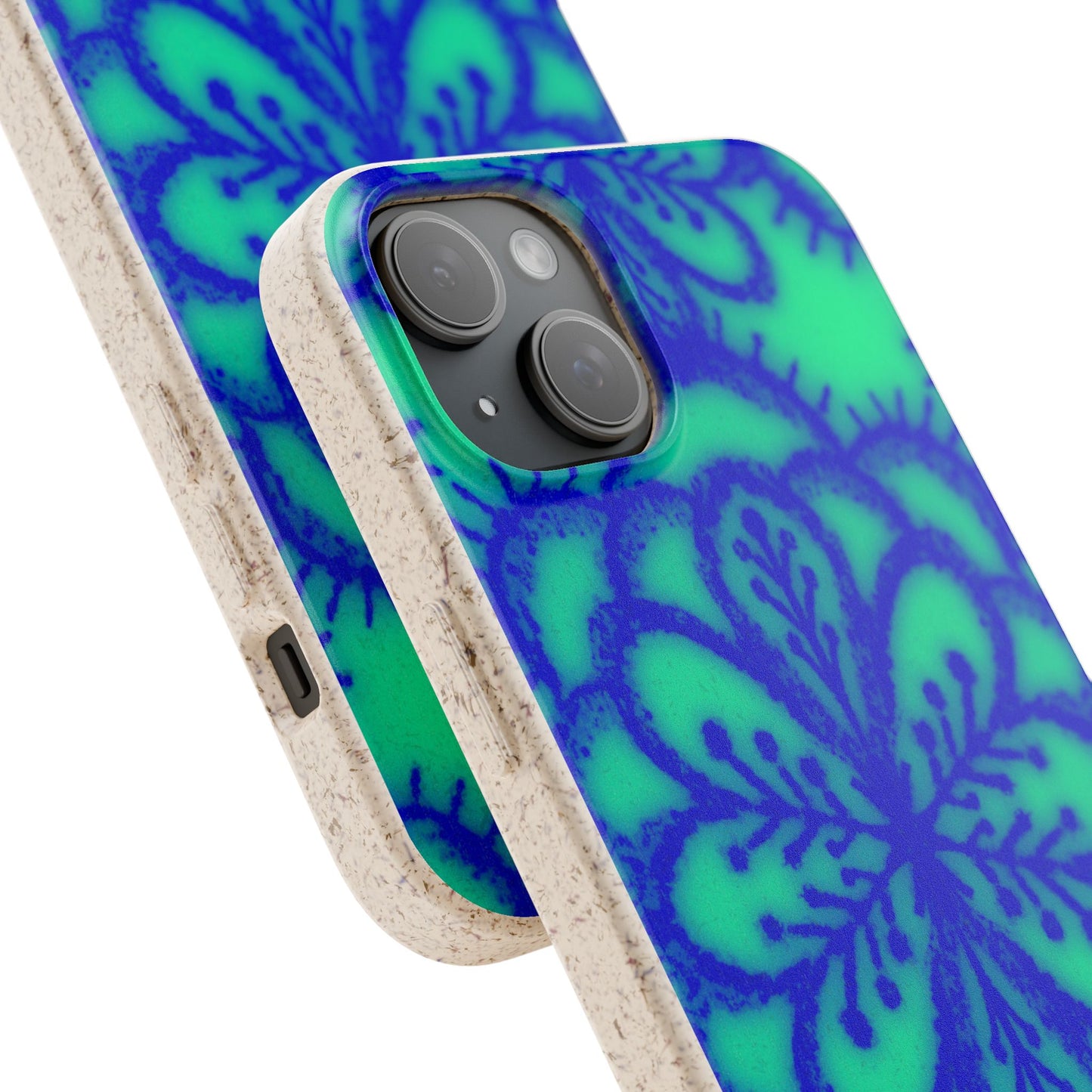 A close-up of a phone case with a blue and green floral mandala pattern and a natural beige textured frame, shown on a white background.