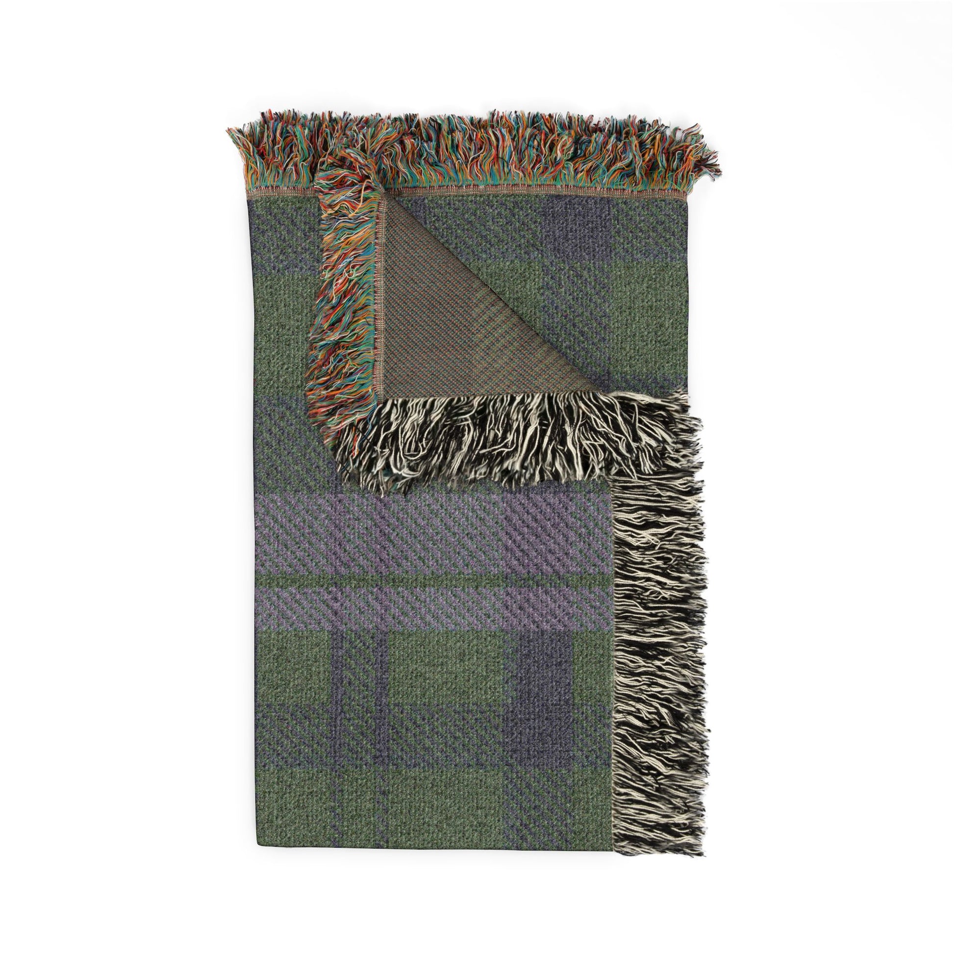 A folded woven throw blanket with a green and purple plaid pattern, featuring multicolor fringe on all sides and a solid olive-green reverse side, shown on a plain white background.