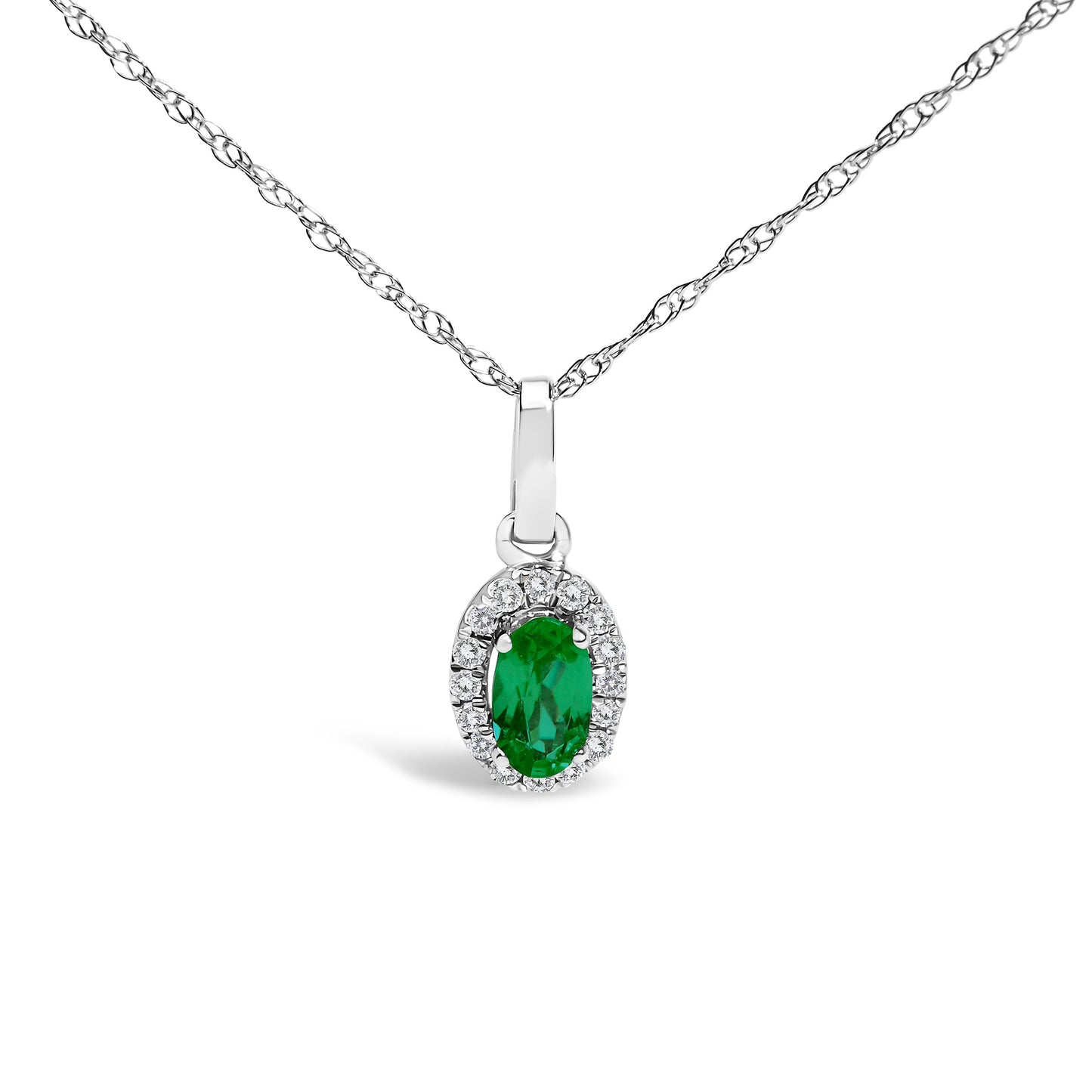 10K white gold pendant necklace featuring a 5x3mm green emerald surrounded by diamond accents in an oval shape.
