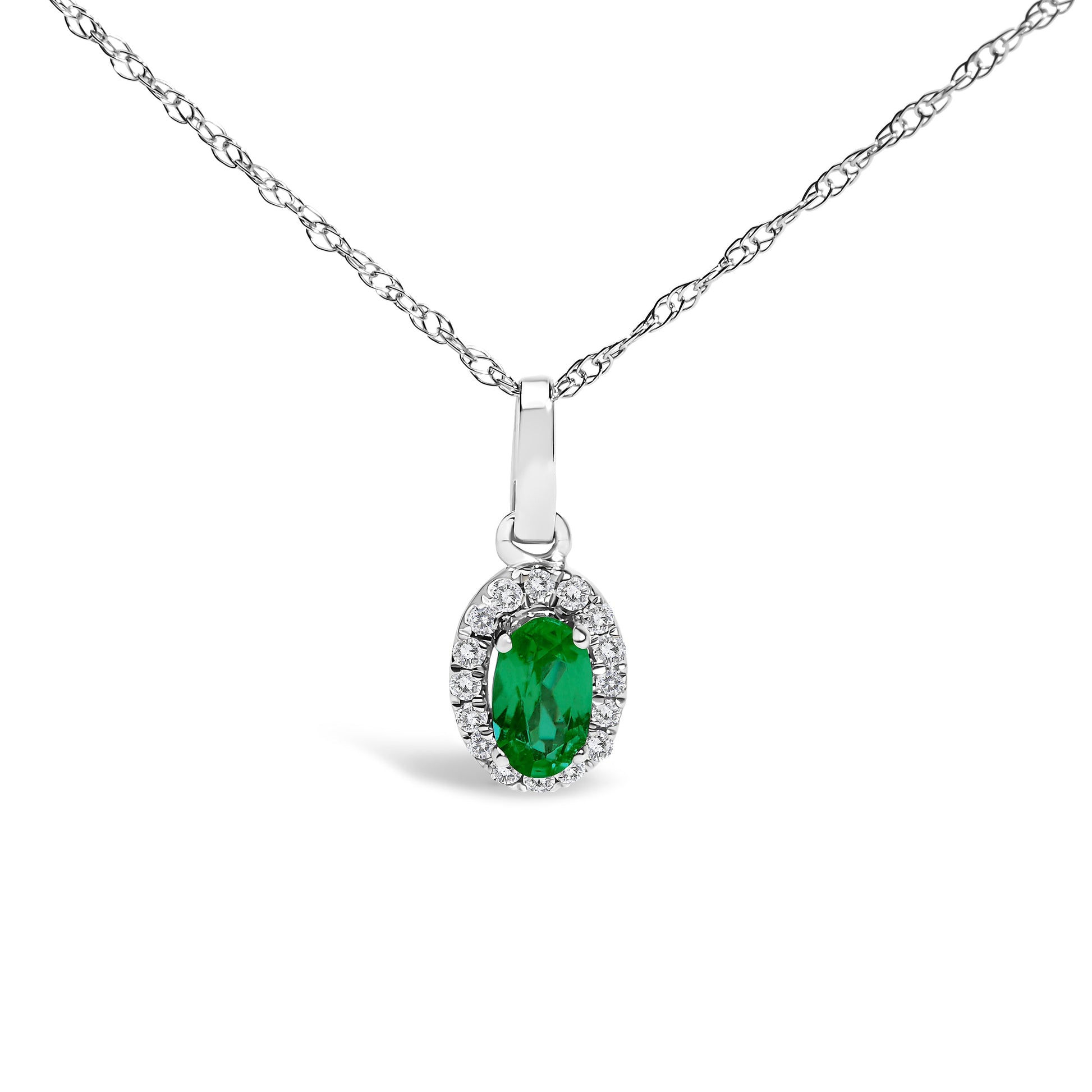 10K white gold pendant necklace featuring a 5x3mm green emerald surrounded by diamond accents in an oval shape.