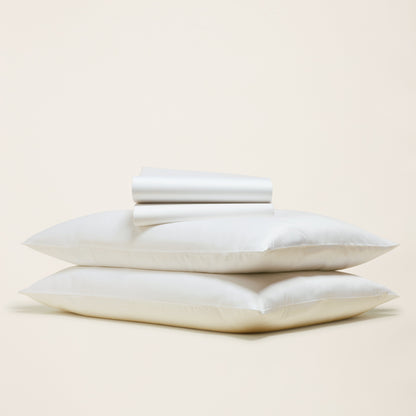 Stack of white pillows on a beige background