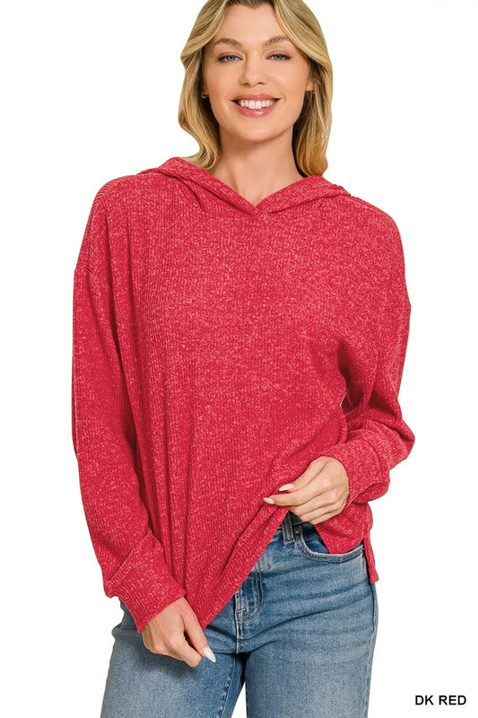 A woman wearing a heathered red long-sleeve hooded sweater and blue jeans, shown against a plain white background with a small 'DK RED' text label in the bottom right corner.