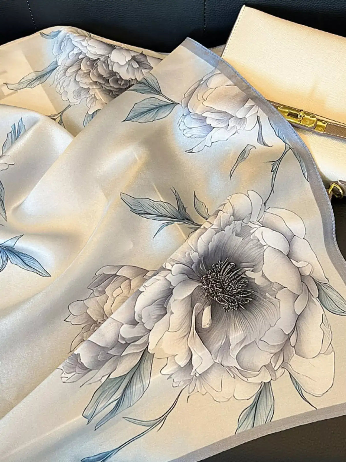Close-up of the floral print pattern on a premium silk square scarf