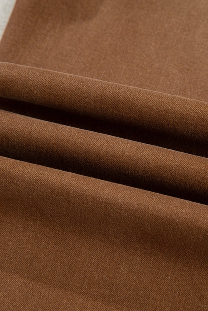 Close up view of brown wide leg cropped jeans.