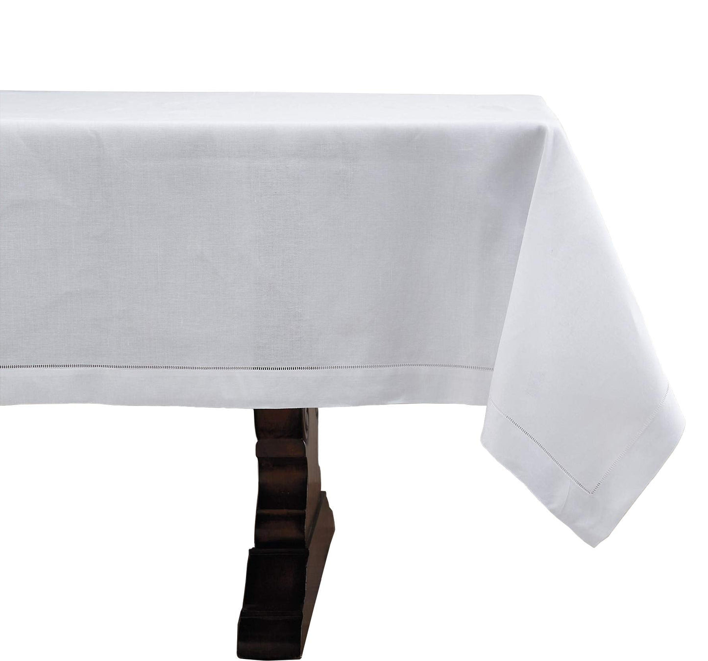 A white tablecloth draped over a dark wooden table, shown against a plain white background.