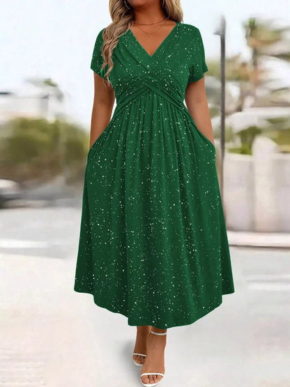 Woman wearing a green dress with a blurred outdoor background