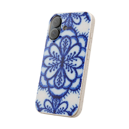 A phone case featuring a blue and white floral mandala pattern on a textured white background, with a natural cork edge.