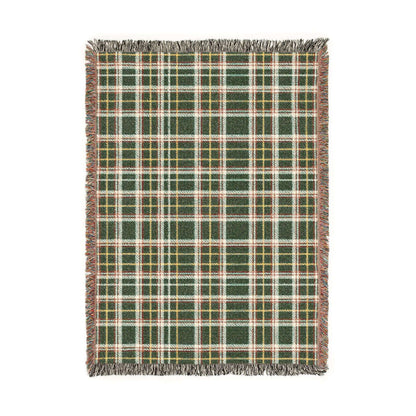 A rectangular woven throw blanket with a green, red, white, and yellow plaid pattern and fringed edges, shown flat against a white background.