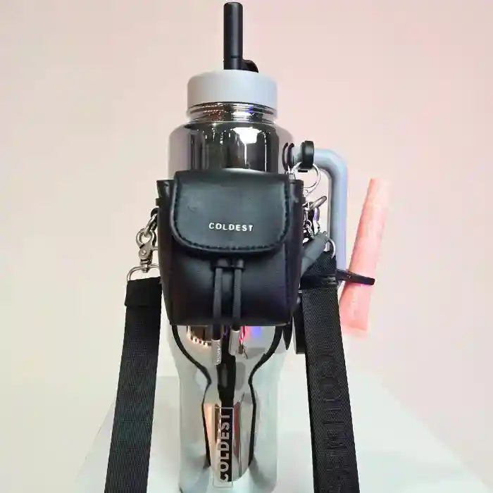 Coldest water bottle in silver with a black mini backpack and squeeze holder attached, featuring a key hanger.