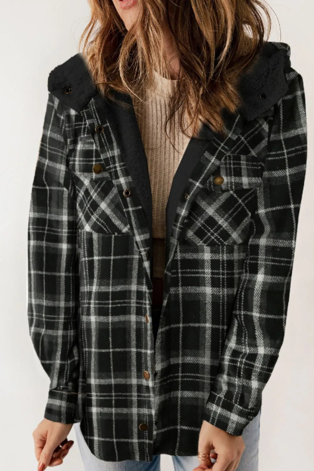 Person wearing a black and gray plaid coat on a white background