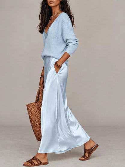 Side view of light blue V-neck top and satin midi skirt, showing the side pocket.