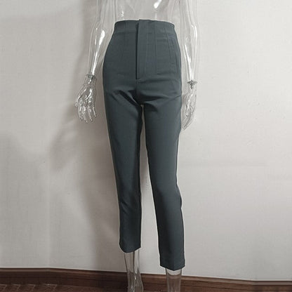 Dark gray pants on a transparent mannequin against a plain background