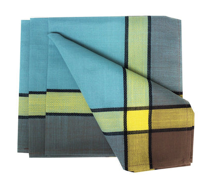 A folded plaid table linen set featuring a teal blue base with yellow, lime green, and brown blocks outlined in black, displayed on a clean white background.