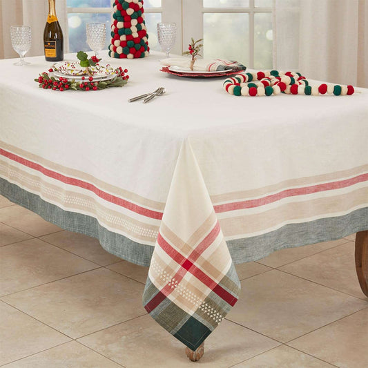 A holiday-themed tablecloth set displayed on a dining table, featuring a white tablecloth with red and beige stripes and a green plaid pattern, along with matching napkins, a festive mini tree, and holiday tableware.