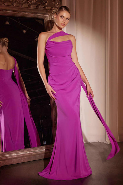 Woman wearing a vibrant purple evening gown in a room with a mirror.