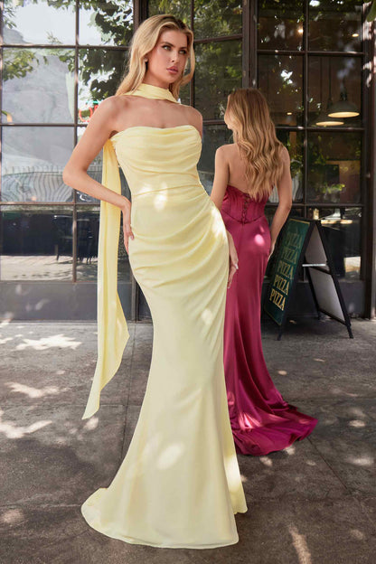 Two women in evening gowns standing outdoors with a building in the background.