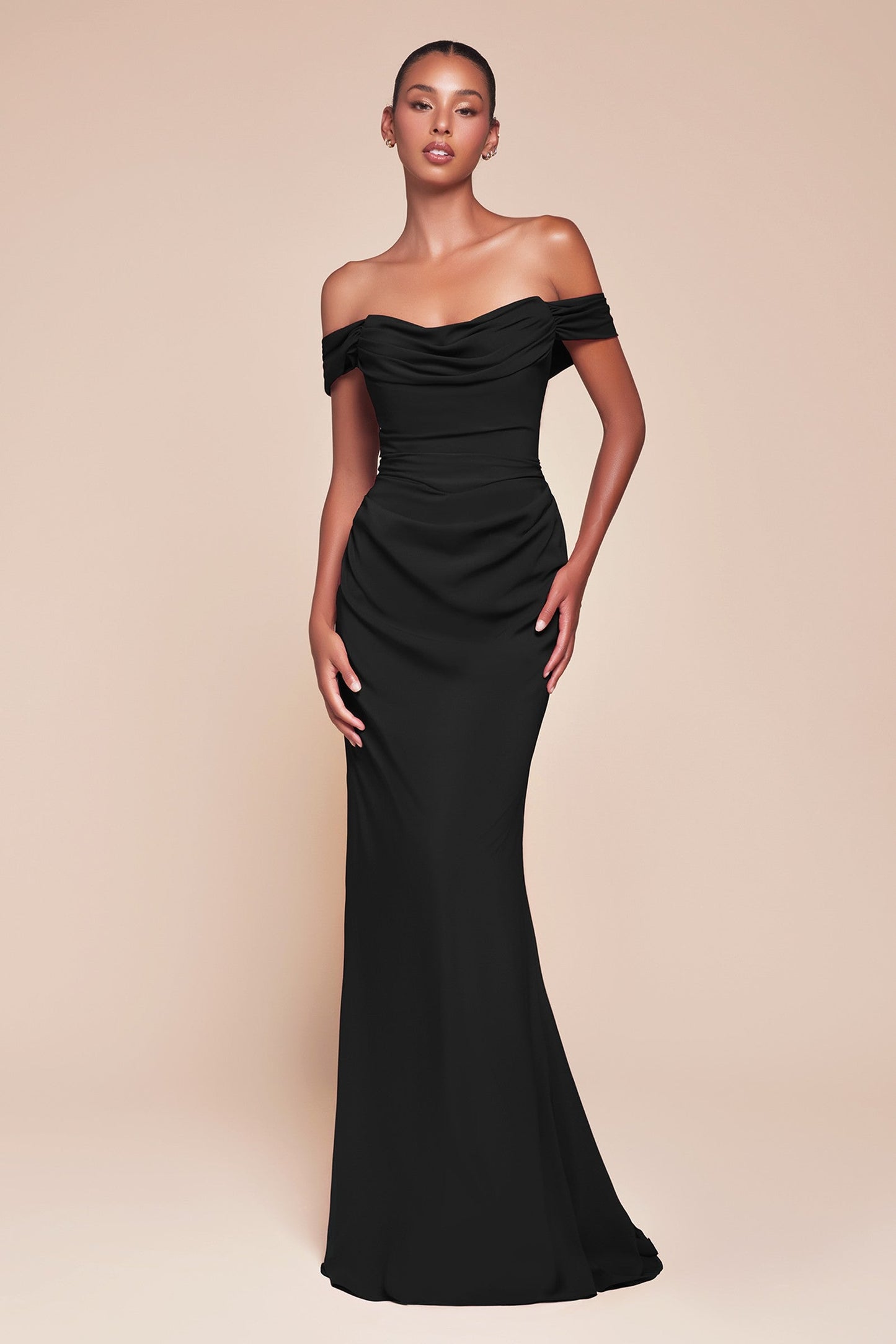 Woman wearing a black off-shoulder gown on a beige background
