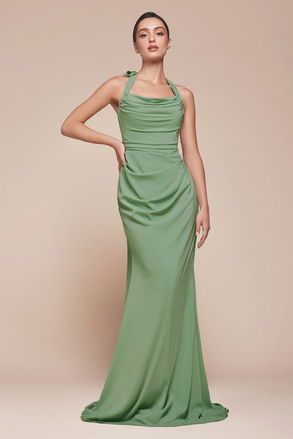 Woman wearing a green evening gown against a beige background