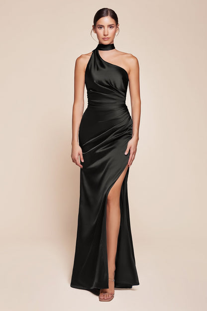 Woman wearing a black halter neck gown with a high slit on a beige background