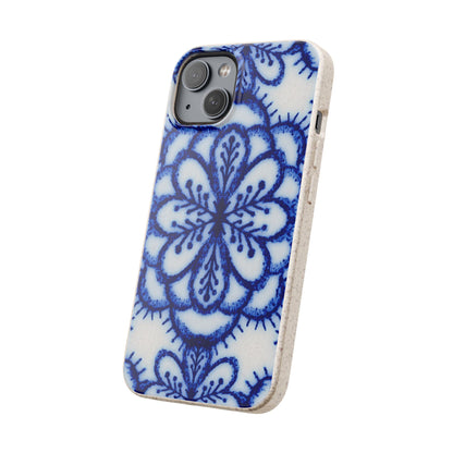 A phone case with a blue and white floral mandala pattern, shown on a light-colored phone against a plain white background.