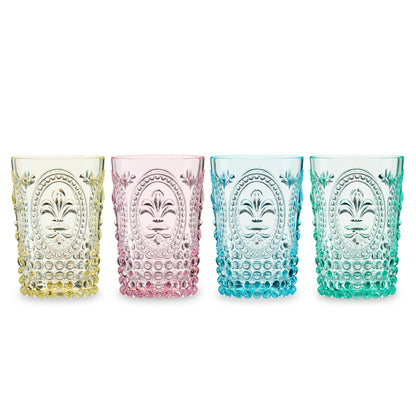 Four colorful glass tumblers with decorative patterns on a white background