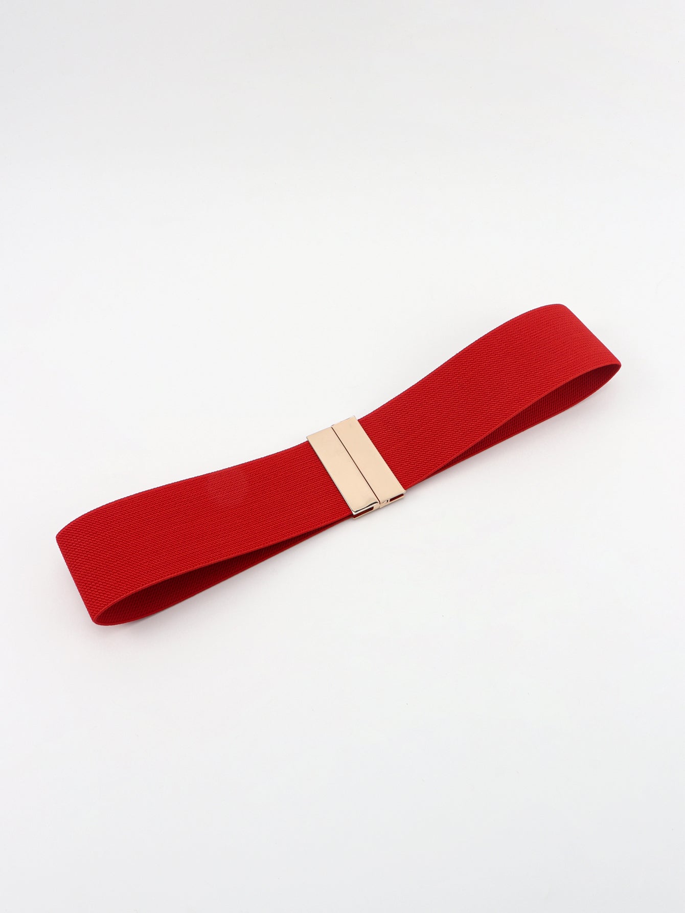 Red belt with a gold buckle on a white background