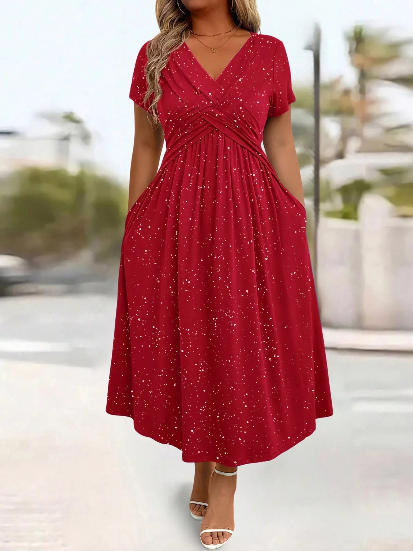 Red dress worn by a person with a blurred outdoor background
