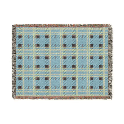A rectangular woven throw blanket with a light blue, beige, and brown plaid pattern and fringed edges, shown flat against a white background.