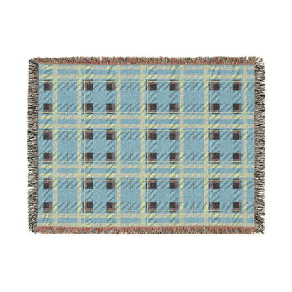 A rectangular woven throw blanket with a light blue, beige, and brown plaid pattern and fringed edges, shown flat against a white background.