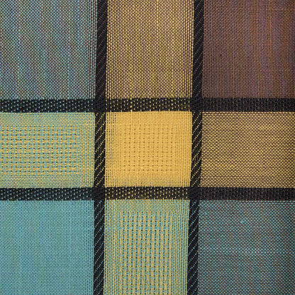 A close-up of a woven fabric with a grid pattern in muted tones of teal, mustard yellow, brown, and black.