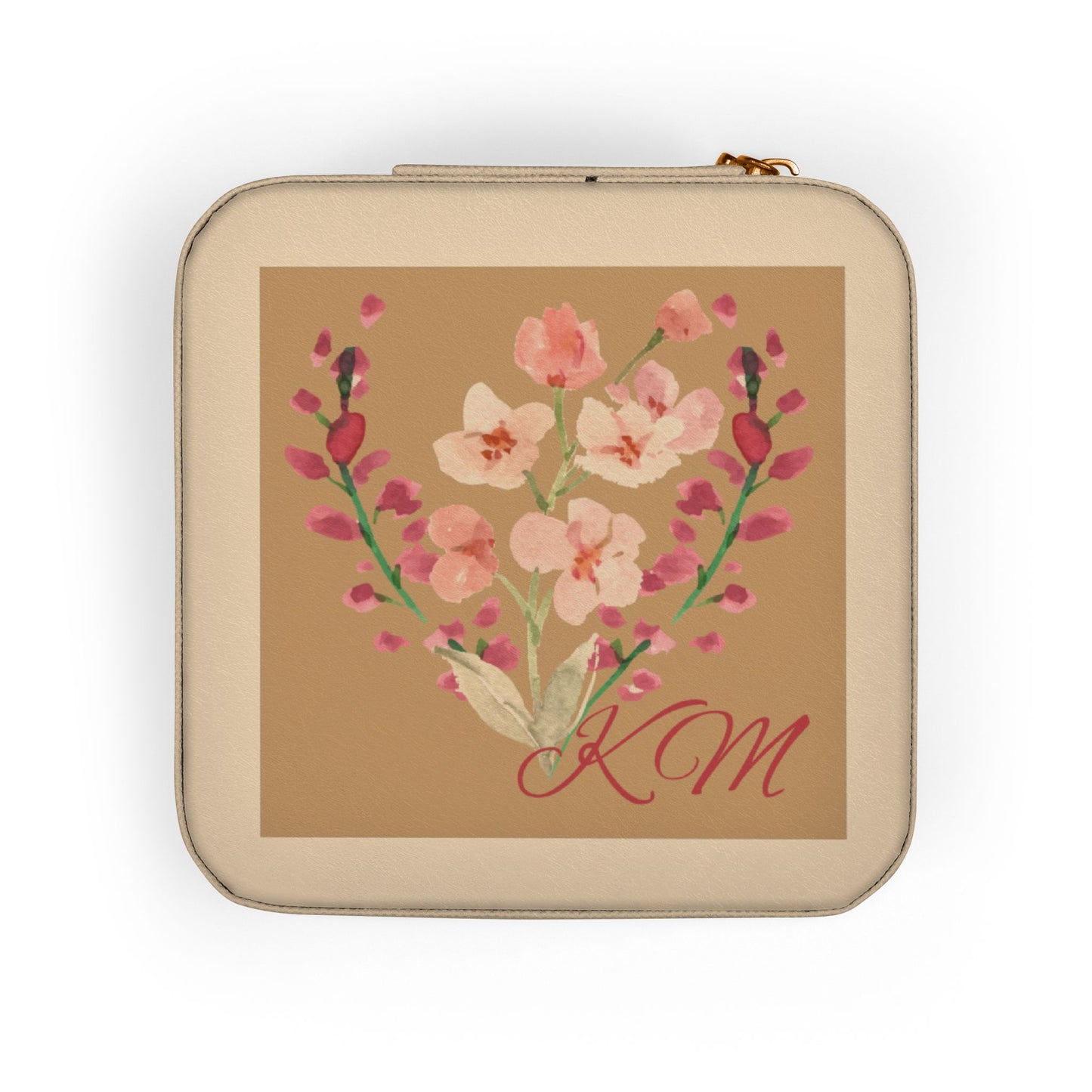 A beige zippered pouch with rounded corners, featuring a central square print of pink flowers on a tan background with the initials 'KM' in red script.