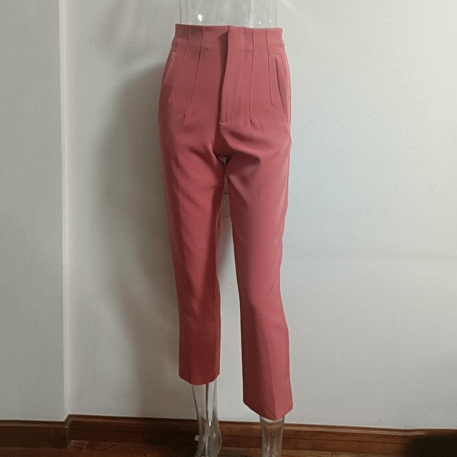 Pink pants on a transparent mannequin against a white wall.