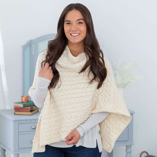Woman wearing a cable knit wool poncho