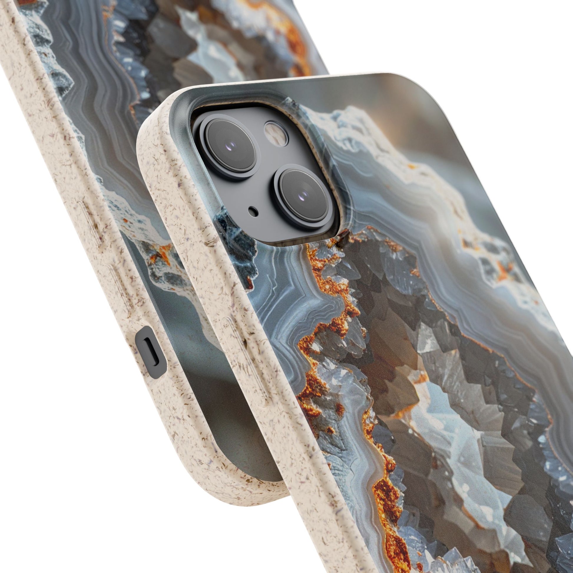 A close-up of a smartphone case with a geode or agate-like abstract pattern in gray, white, black, and rust orange, shown over a phone on a clean white background.