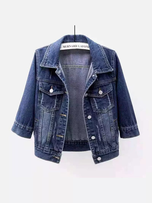 Blue distressed mid-sleeve denim jacket on a hanger, with button front and flap chest pockets.