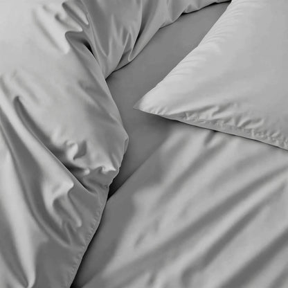 Gray bedding set with pillows on a bed