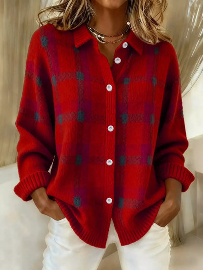 Person wearing a red plaid cardigan with white buttons on a neutral background