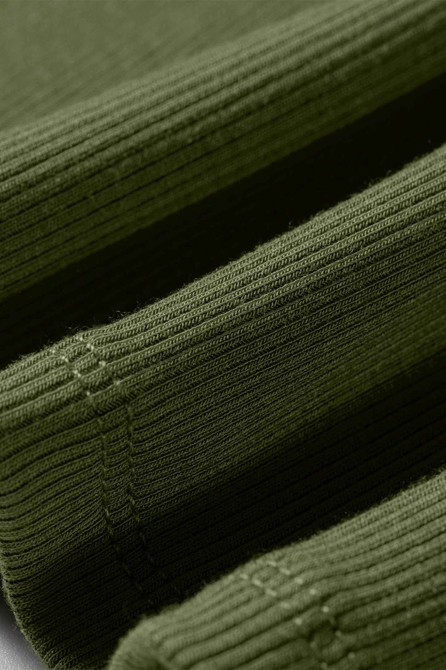 Close-up of green ribbed fabric with a textured pattern